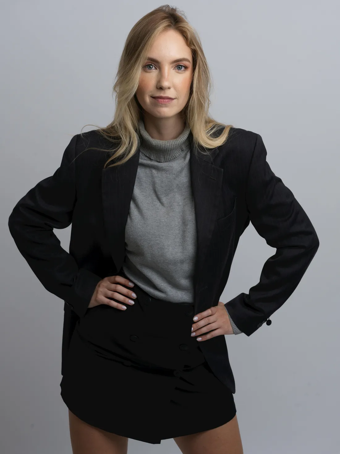 A woman in a tailored black suit